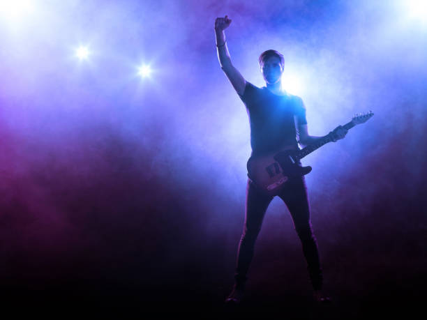 istock Guitarist playing a guitar on stage 829509586
