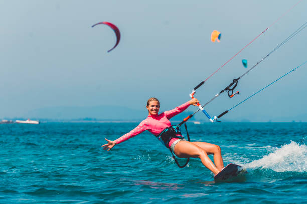Young female kiteboarder enjoying kiteboarding