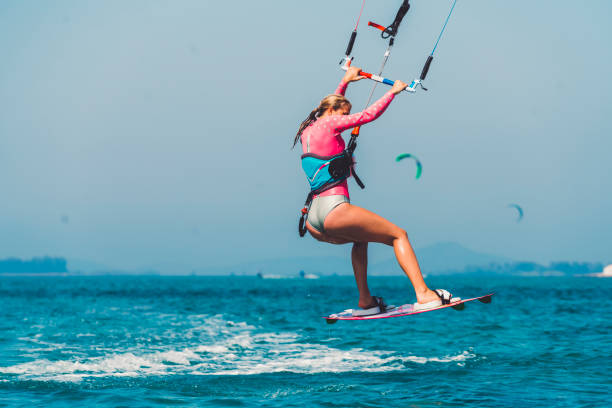 istock Young female kiteboarder jumping in mid-air 829526516