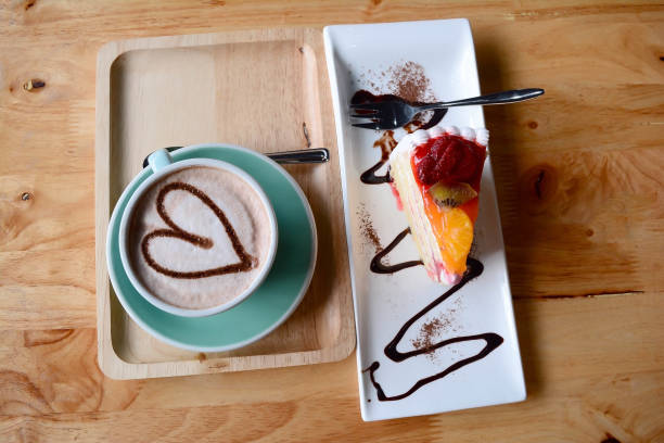 istock a cup of coffee and cake  on  wooden table 829526828