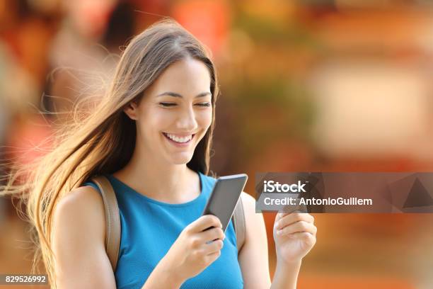 Woman Buying On Line On The Street Stock Photo - Download Image Now - Credit Card, Bank - Financial Building, Paying
