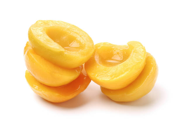 istock Canned peaches on the white background 829529254