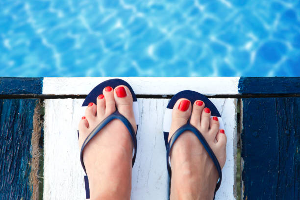 istock Female feet on jetty 829535712