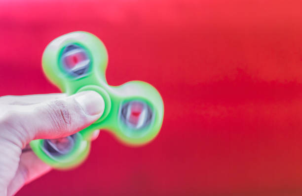istock Teen playing with a fidget spinner 829540250