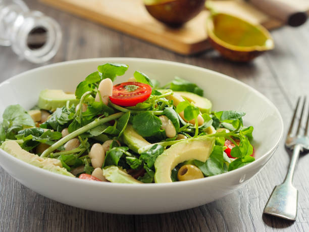 Healthy white beans,avocado and cherry tomatoes salad Home made freshness white beans,avocado ,cherry tomatoes and watercress salad watercress stock pictures, royalty-free photos & images