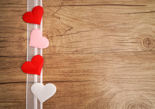 istock heart and ribbon on wooden table 829544230