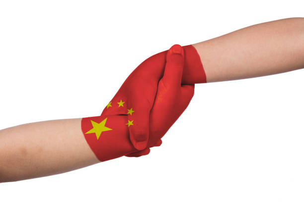 istock Helping hands of two children with China flag painted 829562446