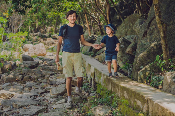 istock Father and son are walking along the forest road 829563030