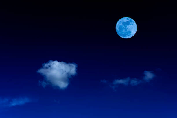 istock Blue moon and cloud  in the dark sky at night 829570972
