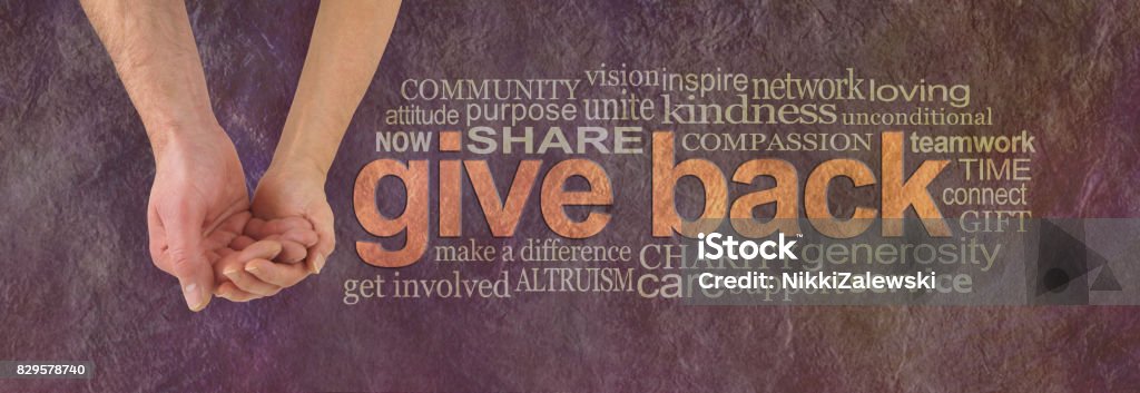 Please donate to our cause Campaign banner with female hand holding male cupped hand on left and a GIVE BACK word cloud  on right against a rustic parchment background Assistance Stock Photo