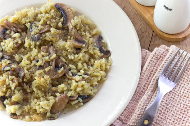 istock Risotto with mushrooms on plate with fork 829582668