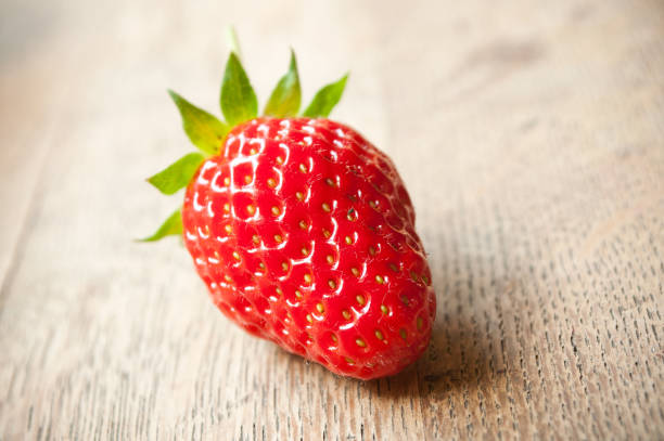 istock strawberries  on wooden table background 829584470