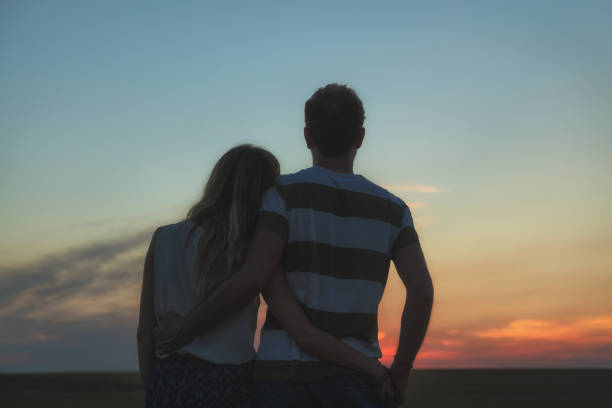 istock Young couple enjoying outdoors in the field. 829599492