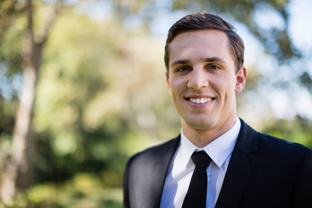 istock Happy groom standing in park 829605826