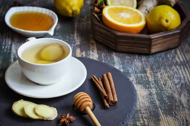 ginger hot  immunity boosting vitamin natural drink with citrus, honey and cinnamon and ingredients - ginger tea cup cold and flu tea imagens e fotografias de stock