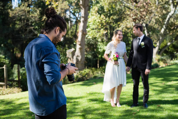 istock Photographer reviewing photographs on digital camera 829609576