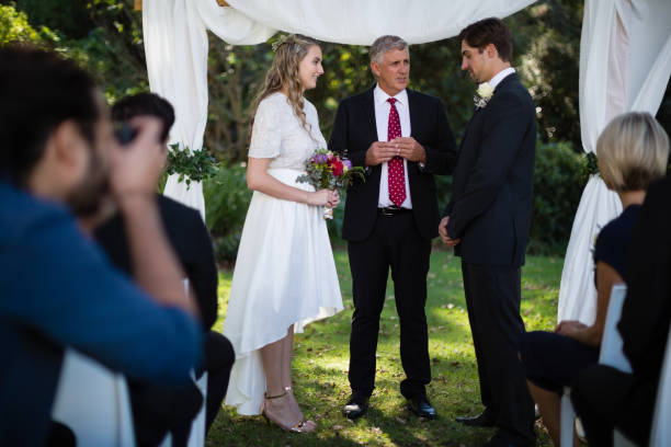 istock Minister giving speech to bride and groom 829616800