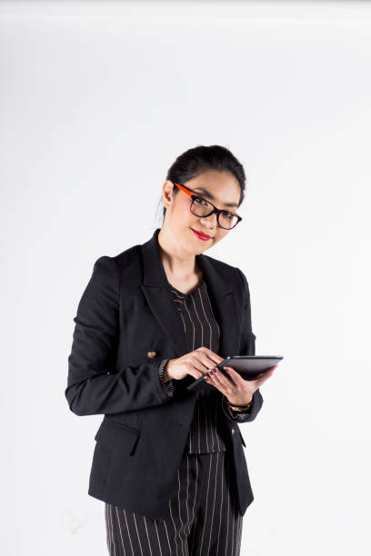 istock Young asian businesswoman working with digital tablet, on white 829617728