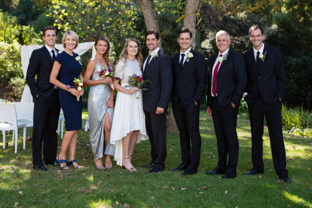 istock Bride and groom standing with guests 829619048