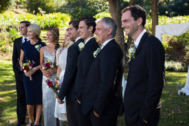 istock Happy bride and groom standing with guests 829619356