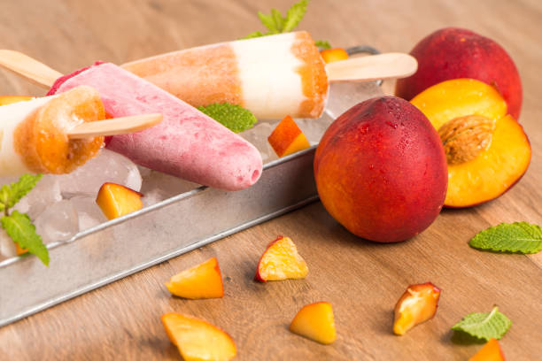 istock Homemade raspberries and peach popsicles 829627788