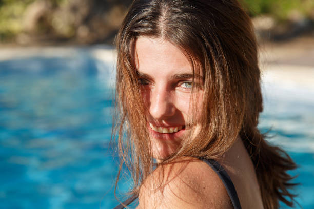 istock Smiling woman in pool 829633832