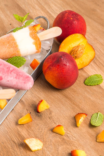 istock Homemade raspberries and peach popsicles 829634130