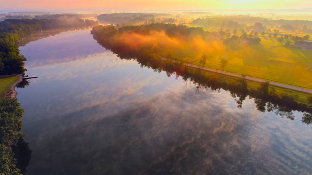 istock Foggy river reflecting sky under Summer sunrise, aerial view 829649276
