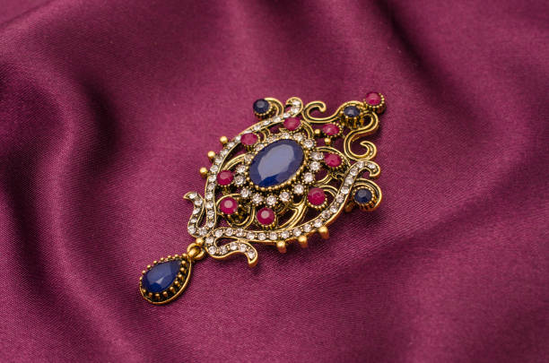 istock Vintage gold brooch with precious stones isolated on white 829656390