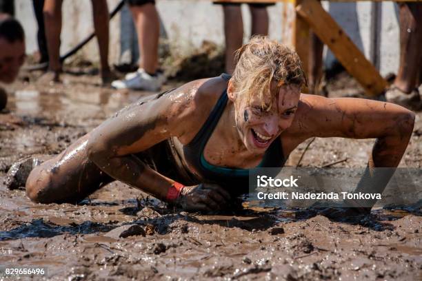 A Woman Crawling Under Barbed Wire Stock Photo - Download Image Now - Obstacle Course, Conquering Adversity, Sports Race
