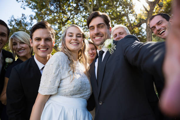 istock Happy couple posing with guests during wedding 829664376