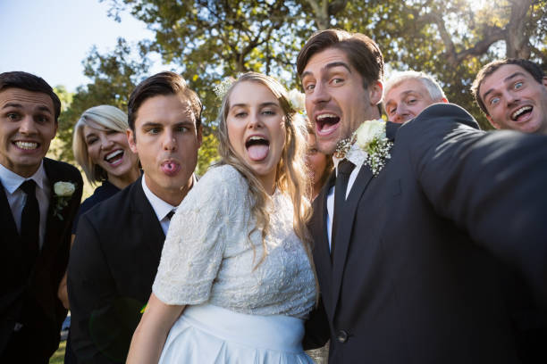 istock Happy couple posing with guests during wedding 829664606