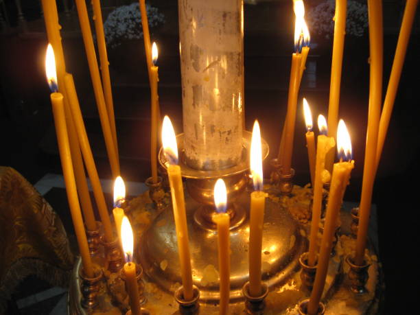 istock Bright burning church candles on candlesticks 829693152