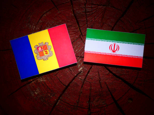 istock Andorra flag with Iranian flag on a tree stump isolated 829703316