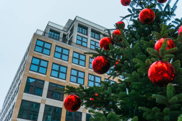 istock christmas tree next to an modern office building 829706772
