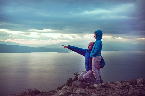 Father And Son On Mountain Hike over the Sea