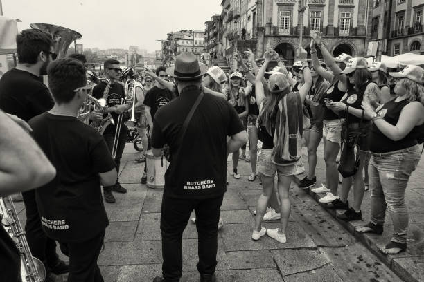 Porto, Portugal - July 29, 2017: A band plays music for a bachelorette party on the Ribeira promenade of Porto.