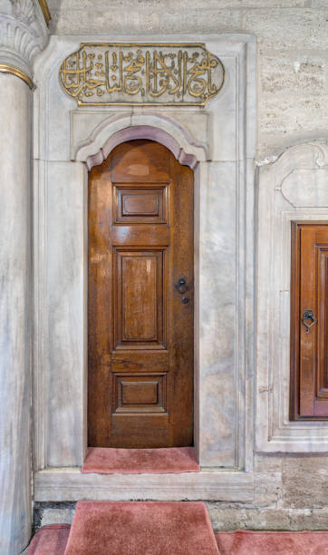 istock Wooden aged engraved door and marble wall 829719078