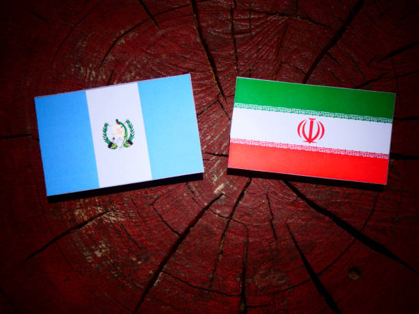istock Guatemalan flag with Iranian flag on a tree stump isolated 829719118
