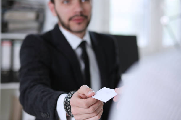 istock Male hand in suit give blank calling card 829728308