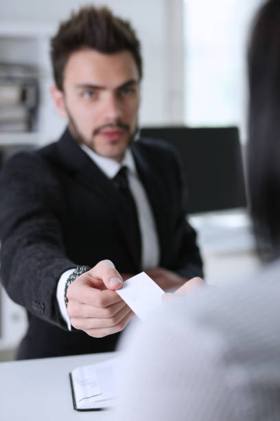 istock Male hand in suit give blank calling card 829728334