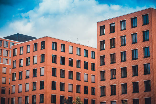 orange or brown finance buildings with cloudy sky