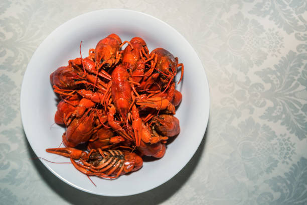 istock Cooked crayfishes in white plate on table 829735602