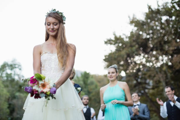 istock Smiling bride holding flower bouquet 829735954