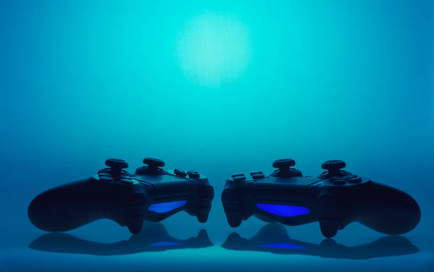 istock game joysticks sillhouettes - without any logos on blue background 829748378