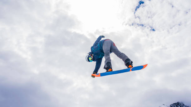 istock Male snowboarder in mid air 829762334