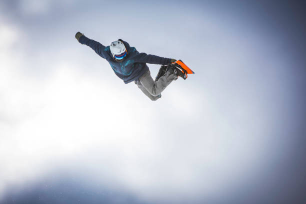 istock Male snowboarder in mid air 829762346