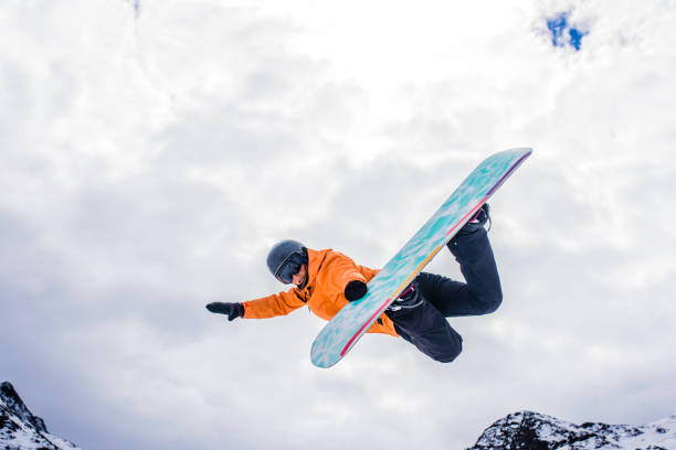 istock Female snowboarder in mid air 829762366