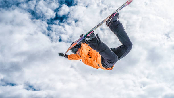 istock Female snowboarder in mid air 829762370