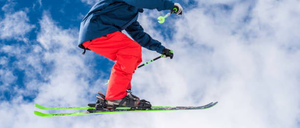 istock Male skier jumping over half pipe 829762372